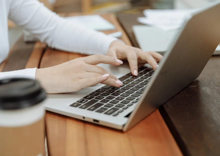 Virtual assistant preparing property valuation reports and documents on a laptop.